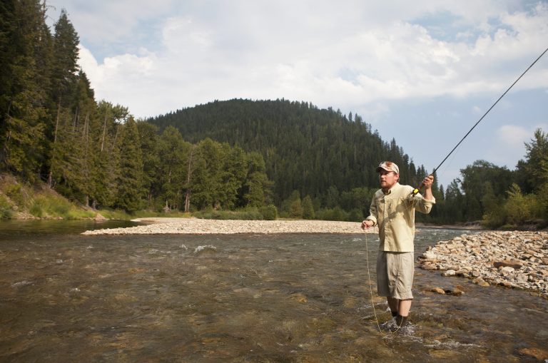 Young man fly fishing an Idaho river.