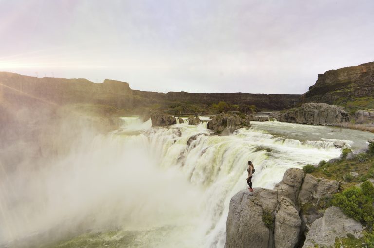 Woman standing next to Shoshone Falls
