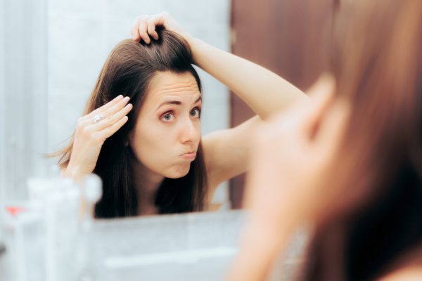 Person aging prematurely looking in the mirror